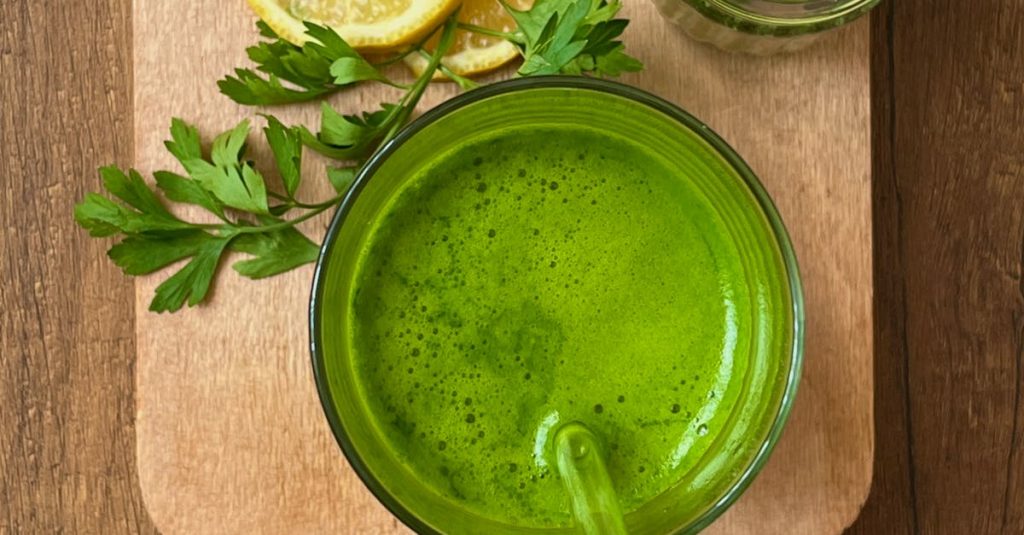 Invigorating green juice with lemon and parsley for a refreshing detox boost.