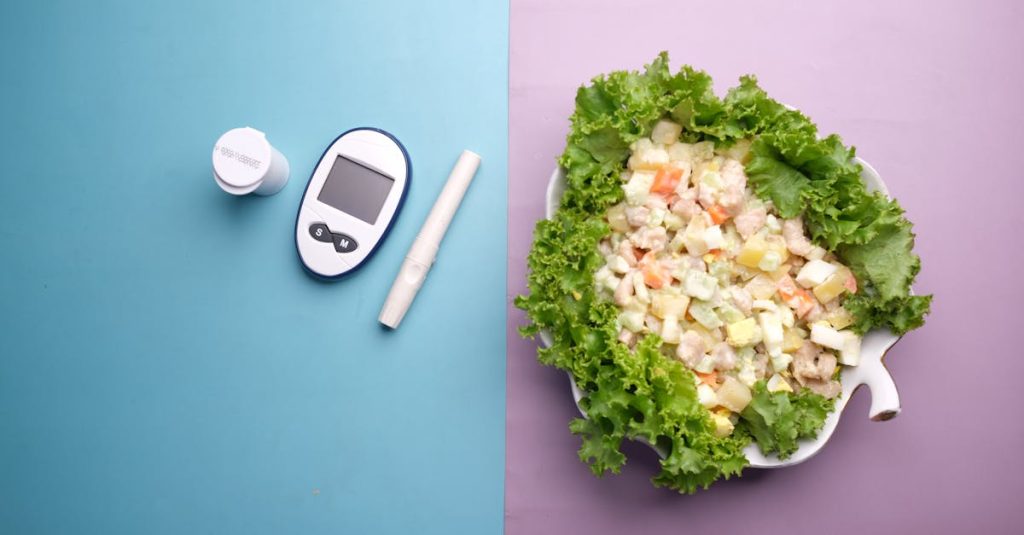 Top view of diabetes equipment and fresh salad representing healthy living.