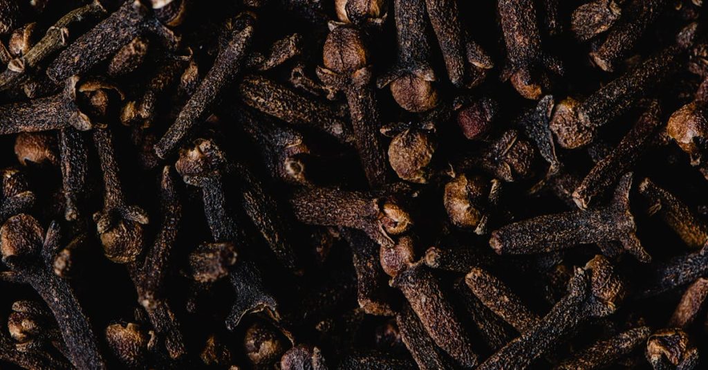 Close-up view of aromatic dried cloves, showcasing texture and rich brown color.