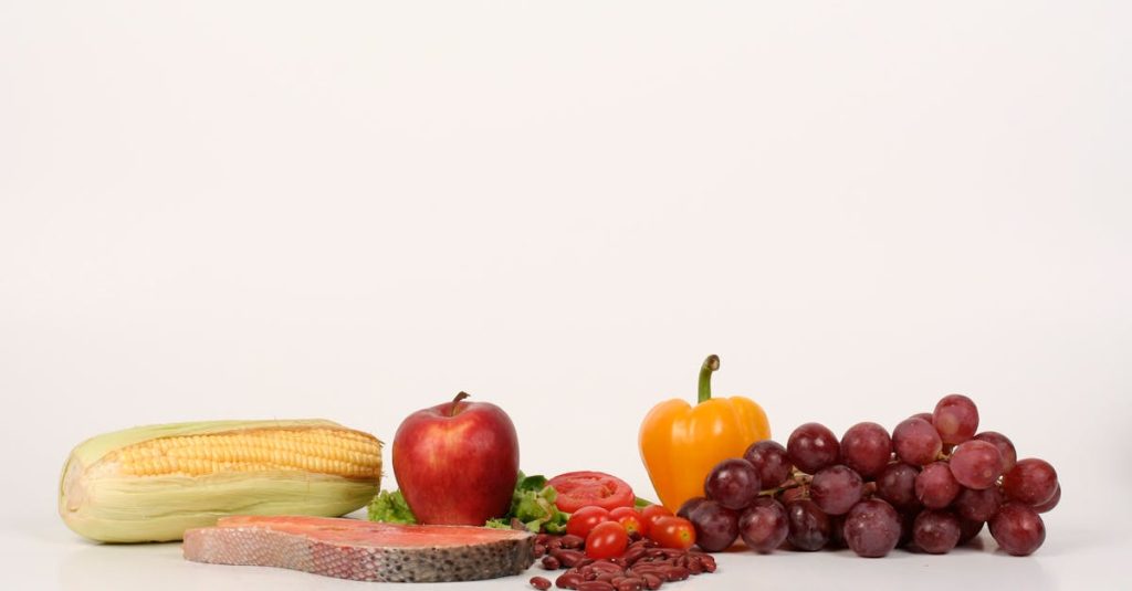 Vibrant display of fruits, vegetables, and salmon on a white background, ideal for food and health themes.